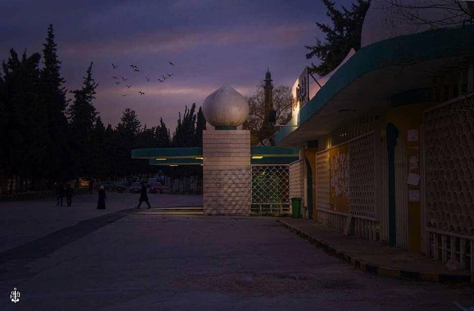 University of Jordan's main gates at night.